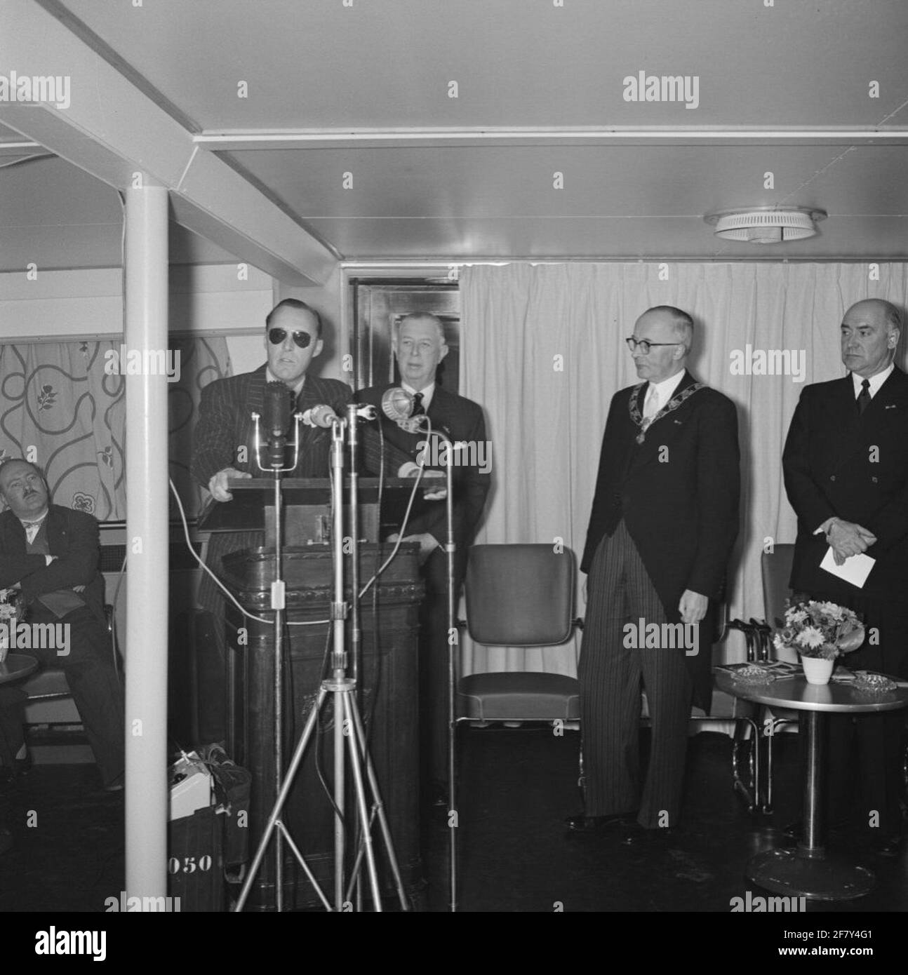 Commissioning of the Radarnet Nieuwe Waterweg on November 30, 1956 by ZKH Prins Bernhard (1911-2004, behind Katheder). It just made it possible to monitor all ship movements on the Nieuwe Waterweg van Hoek van Holland to Rotterdam.Second the mayor of Rotterdam Mr. G.E. from Walsum (1900-1980) and on the right the State Secretary of Marine (Stasmar) H.C.W. Moorman (1899-1971). Stock Photo