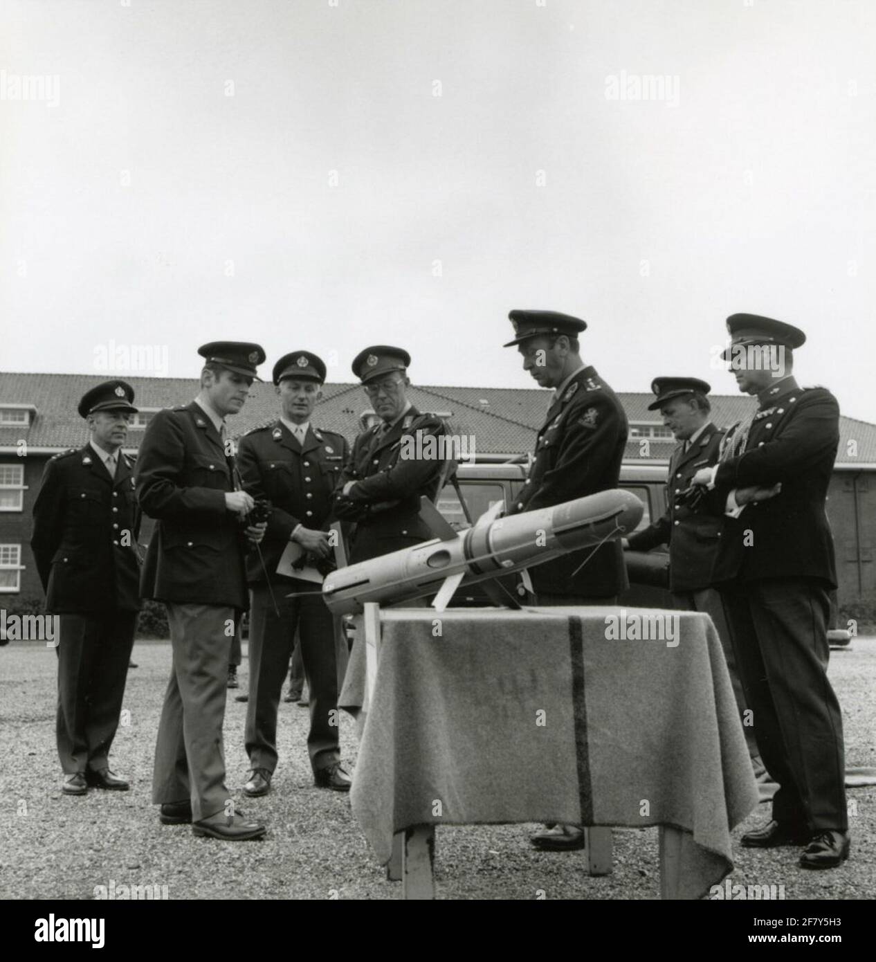 ZKH Prins Bernhard (General of Armed Forces Inspector) explains the operation of an anti-tank rocket. Different high officers look interested in an interest. Stock Photo