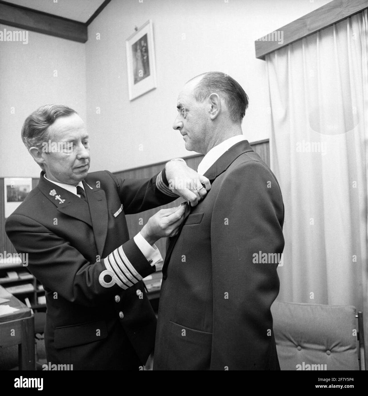 Prepen by the Director of Rijkswerf (RW) Captain-Ter Sea of the Technical Service Ir. T.J.P.M. STOLTZ (1928, Left) of a distinction in the Order of Orange-Nassau at an employee of the RW in 1975. Stock Photo