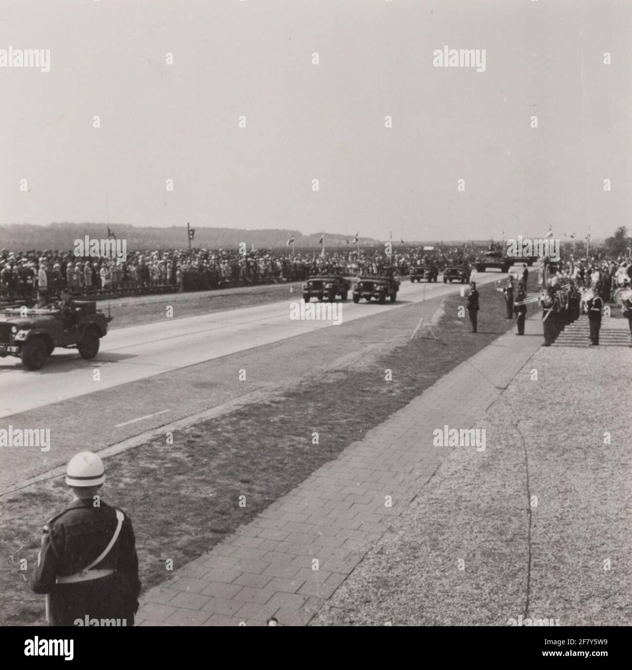 Five M38A1 Nekf Jeeps pass the downfall with, among others, H.M. Queen Juliana and Z.K.H. Prince Bernhard during the Parade in Ede on the occasion of Liberation Day. Stock Photo