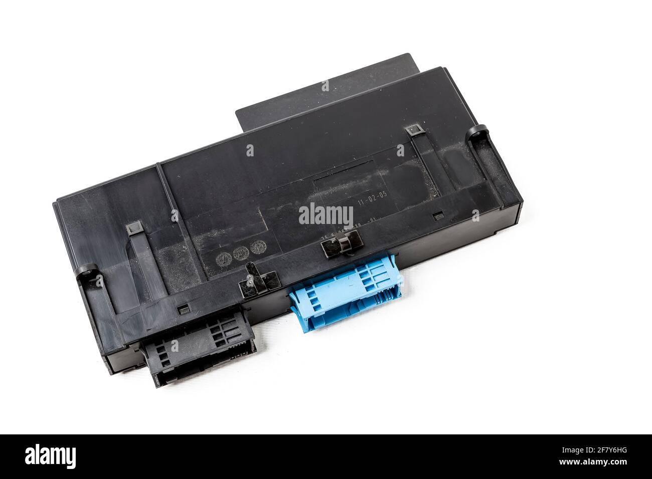 Plastic electronic control unit with black and blue connectors on a