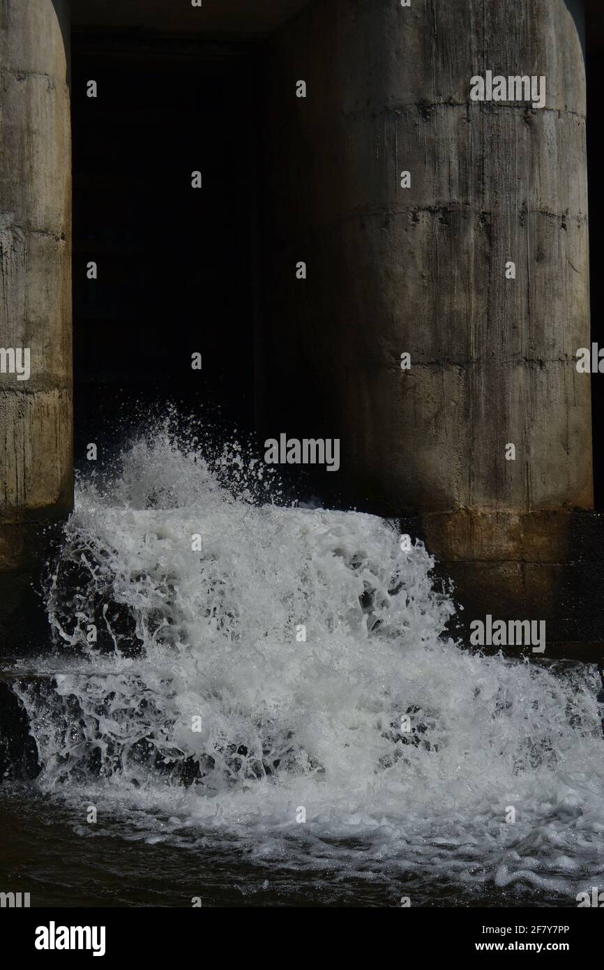 water flowing through dam Stock Photo