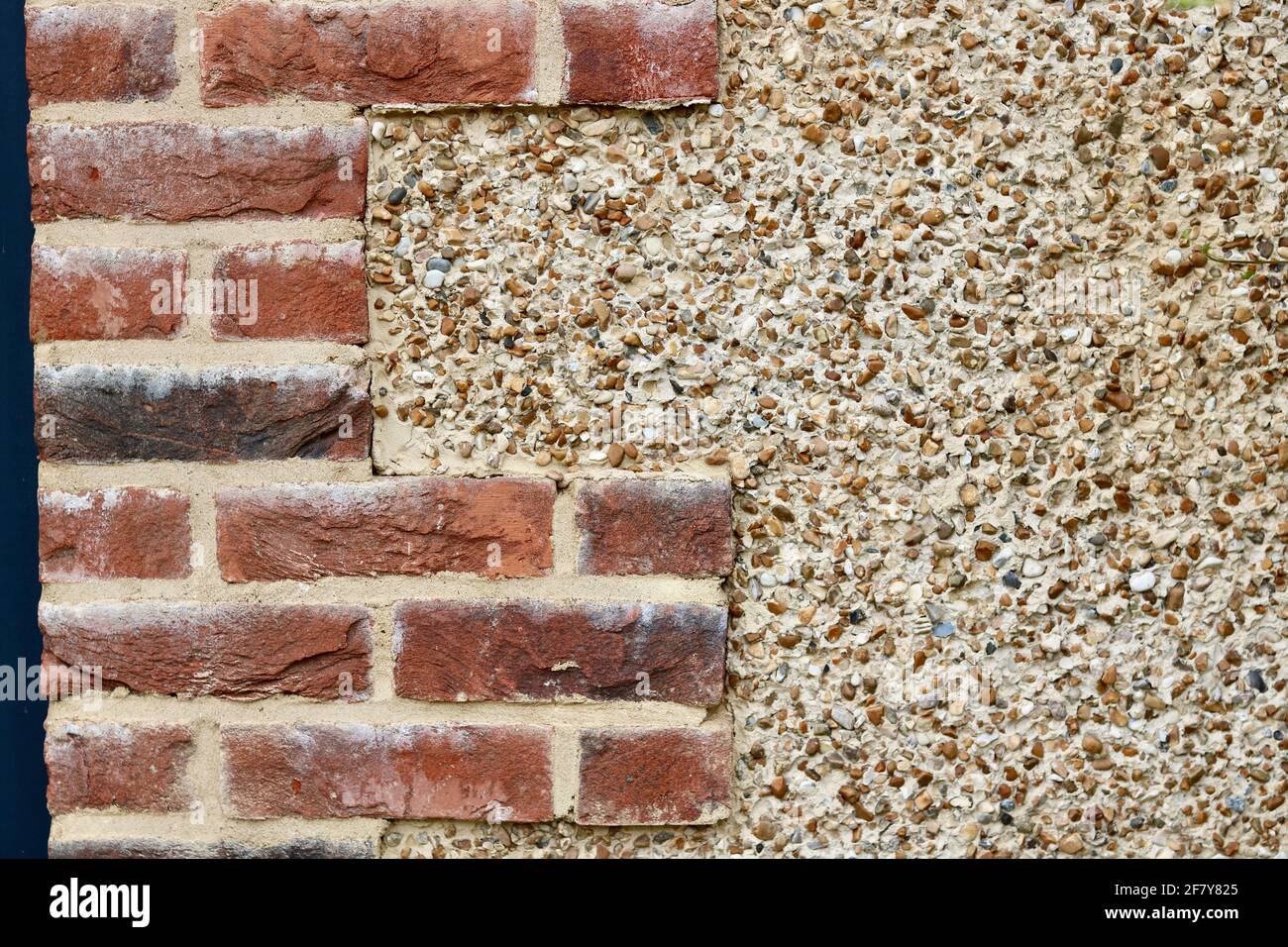 Building background with combination of bricks and pebble dashing with copyspace Stock Photo