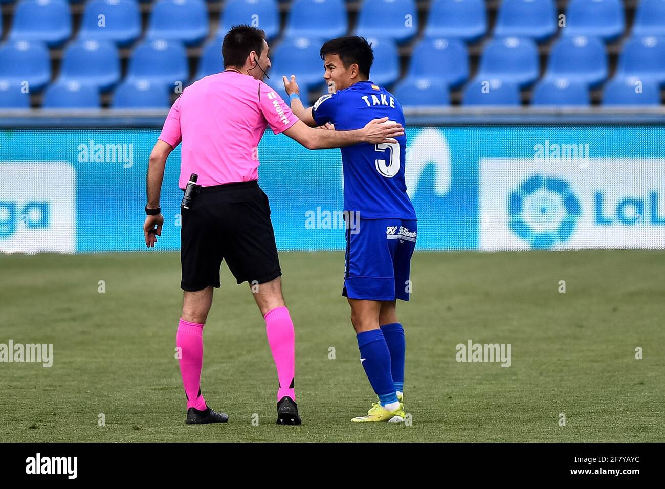 GETAFE, SPAIN - APRIL 10: referee Ricardo De Burgos Bengoetxea and Takefusa Kubo of Getafe CF reacts during the La Liga Santander match between Getafe Stock Photo
