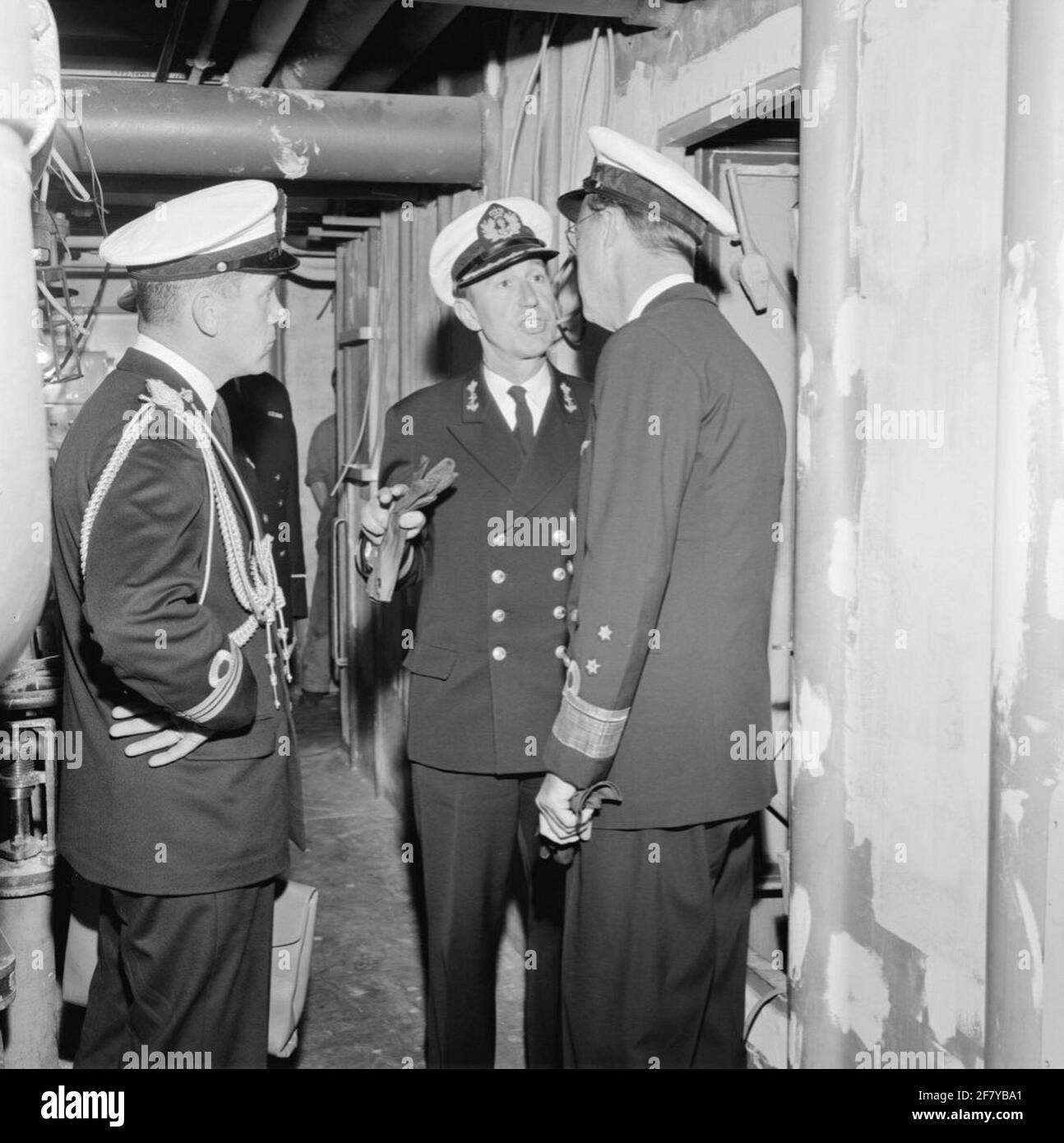 Prince Bernhard, in his position as Inspector General of the Armed Forces (IGK) and in the Uniform of Lieutenant Admiral (LTADM), visit the Rotterdamsche Droogdok Maatschappij (RDM) at the Heijplaat in Rotterdam. The seven provinces (Zipprov) (C 802) and the pool star (A 835), the supply ship for the Royal Netherlands Marine (KM), which after the commissioning as Harer Majesteits (Hr.Ms.) will go into the pool star. On board the pool star, the IGK is in conversation with (probably) the commander of the Poolster, Captain-Ter-Sea (KTZ) W.P. Coolhaas. Stock Photo