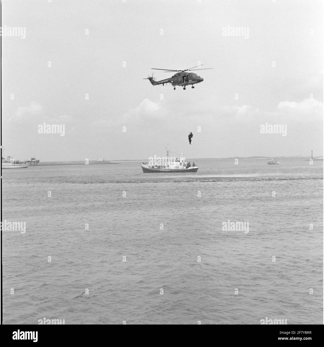 Exercise Pesonentransport from a floating platform by the Westland SH-14D Navy Lynx Helicopter with registration 283 (1981-approx. 2012) in collaboration with the bright rescue boat Suzanna (1968-1998) of the Royal North and South Holland Redding Company (Knzhrm) In May 1990 .. Stock Photo