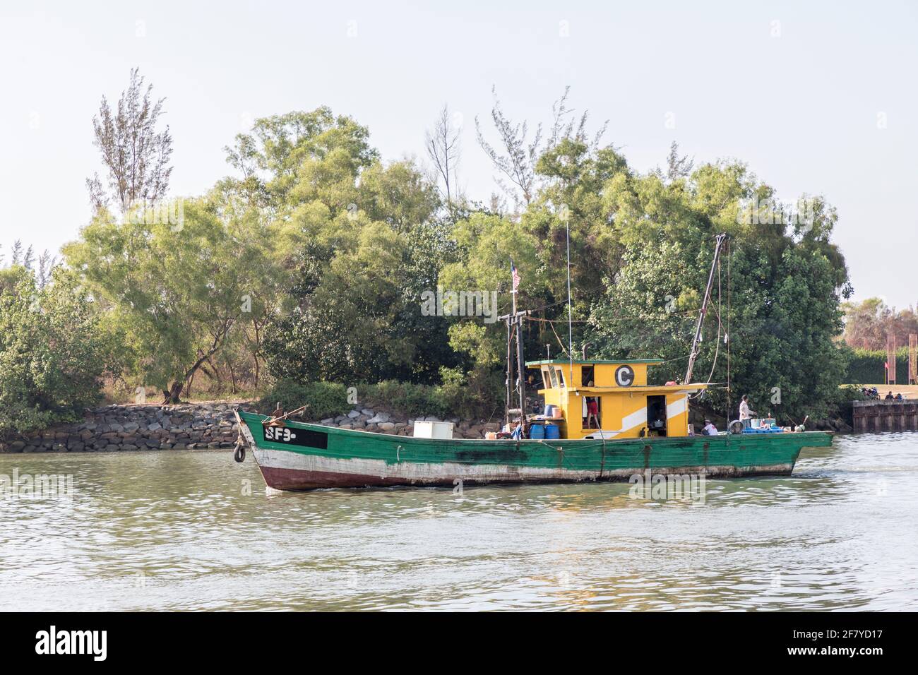Boat sailing out of river in Miri, Malaysia Stock Photo