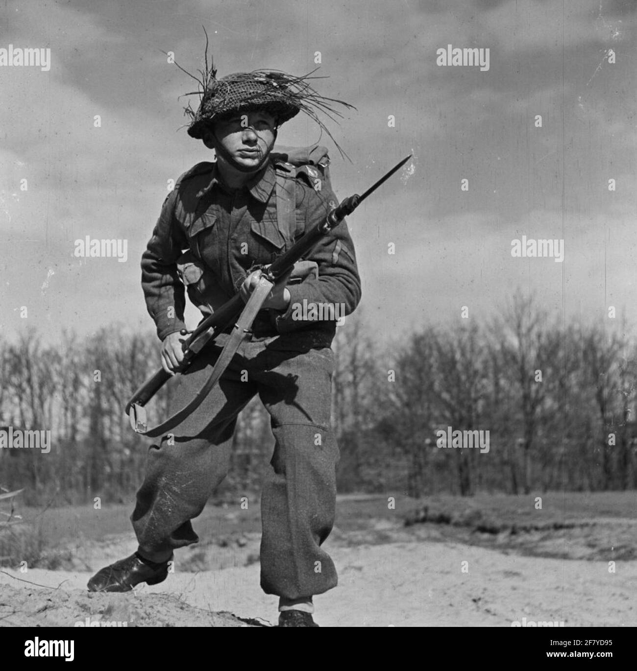 Infanterist with packaging and Lee Enfield rifle with bayonet on during a field service exercise. Stock Photo