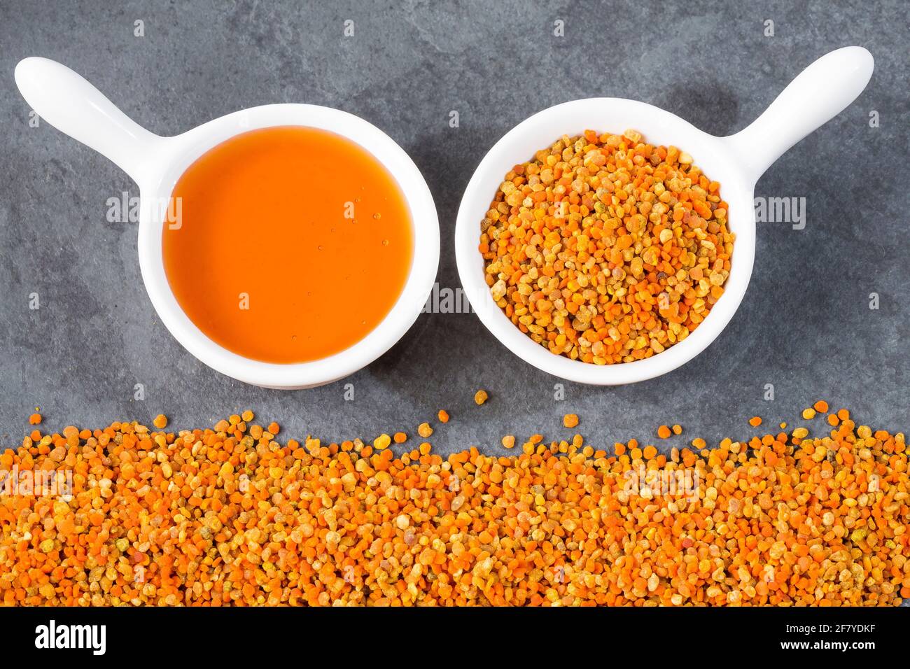Bee honey and pollen grains. Natural sweetener Stock Photo - Alamy