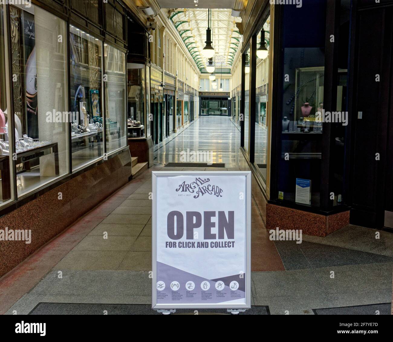 Glasgow, Scotland, UK 10th April, 2021 Lockdown Saturday saw lots of shoppers as the better weather increased the footfall in the city but the argyle arcade continues to be empty despite its hopeful sign.  Credit: Gerard Ferry/Alamy Live News Stock Photo
