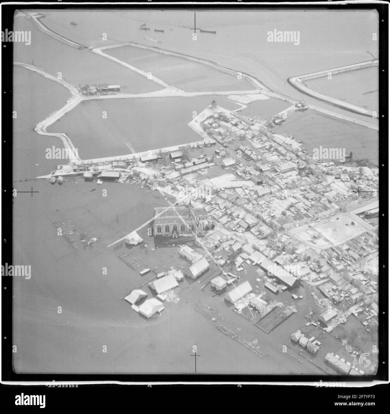 Water shortage disaster 1953. Air photo of Brouwershaven and an overview of the area affected by the disaster. Midden the Grote or Sint Nicolaaskerk on the church square and something above the right mill De Haan on the northwal. Stock Photo