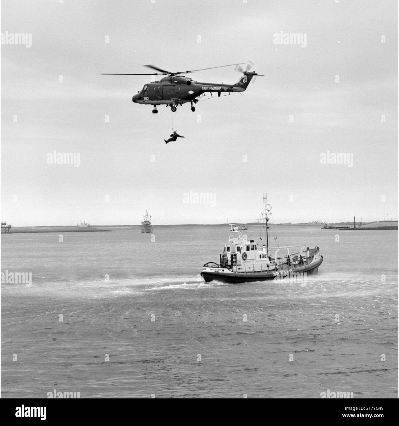 Exercise Person transport From a floating platform by the Westland SH-14D Navy Lynx Helicopter with registration 283 (1981-approx. 2012) in collaboration with the bright rescue boat Suzanna (1968-1998) of the Royal North and South Holland Redding Company (Knzhrm) in May 1990. Stock Photo