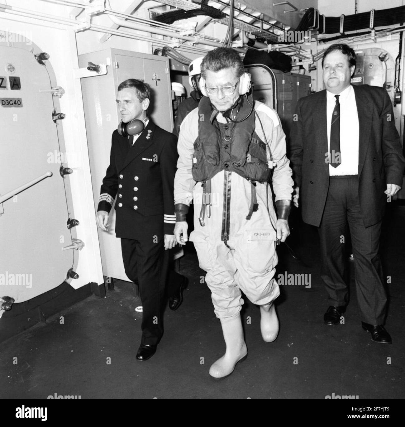 The Minister of the Interior, Drs. C.P. Van Dijk, visiting HR. Ms. Bloys from Treslong (1982-2003). The minister, dressed in a kite overall, walks into the hangar together with the commander, captain-lieutenant at sea (Kltz) L.L. Buffart. Stock Photo