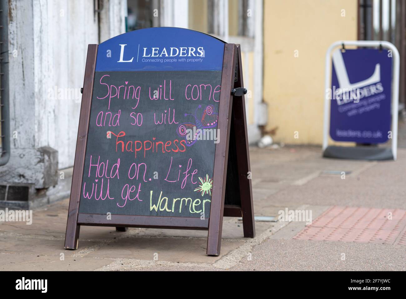 Uplifting message chalked on a blackboard outside Leaders estate agents, as UK looks to roadmap out of lockdown from COVID 19 pandemic Stock Photo
