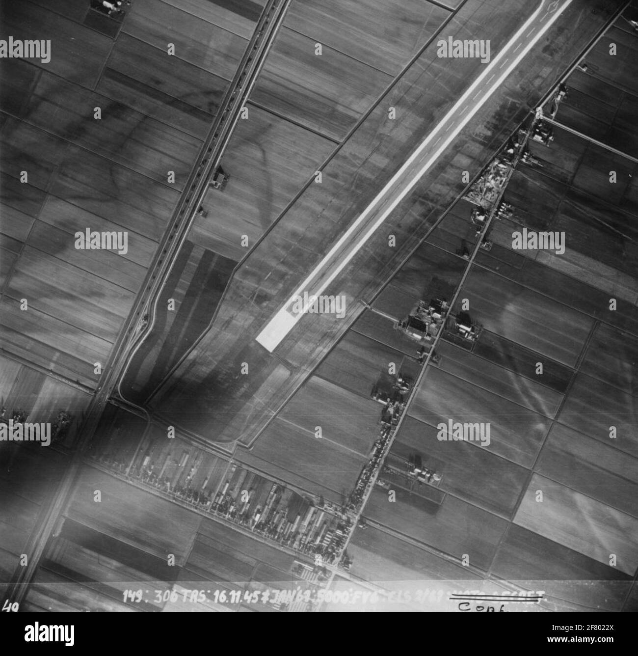 Aerial view of the Kaagbaan (06-24) from Schiphol Airport. The road to the left is the current A4. The current Schiphol South and Center is located at the unbuilt part in between this. This aerial photo is classified as NATO-Confidential. Stock Photo