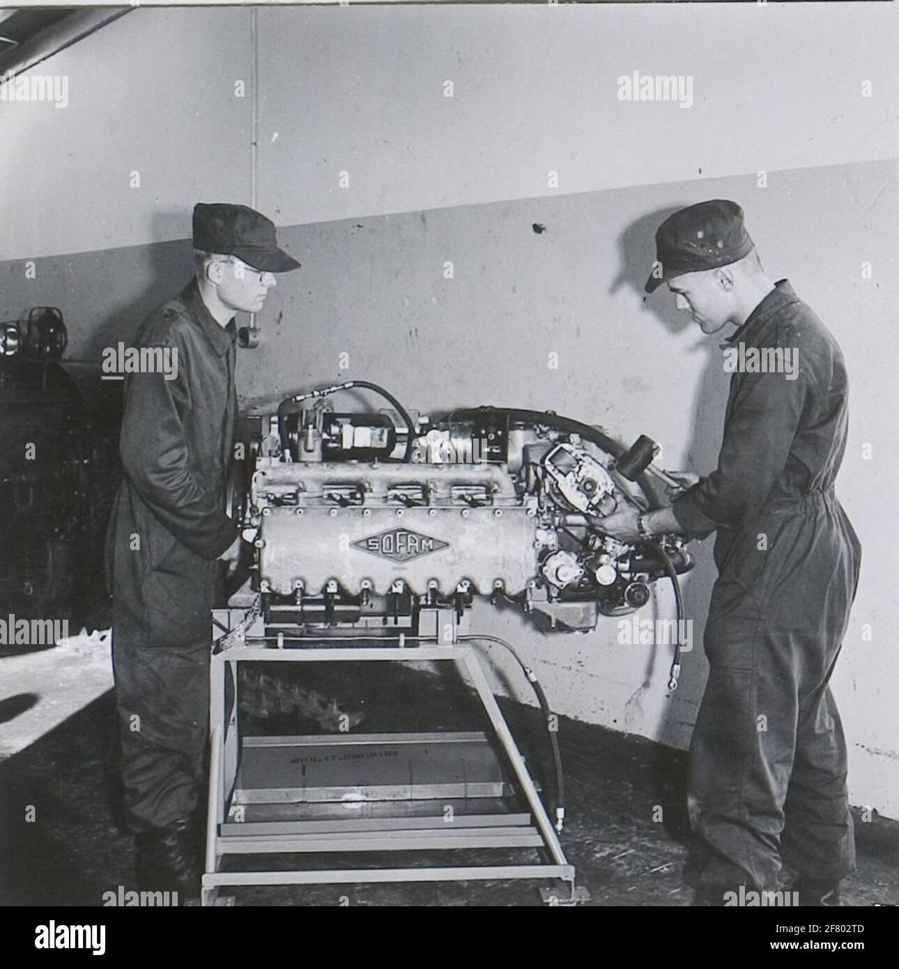 Two conscripts work here to a SOFAM engine from an AMX-13 armored vehicle. Stock Photo