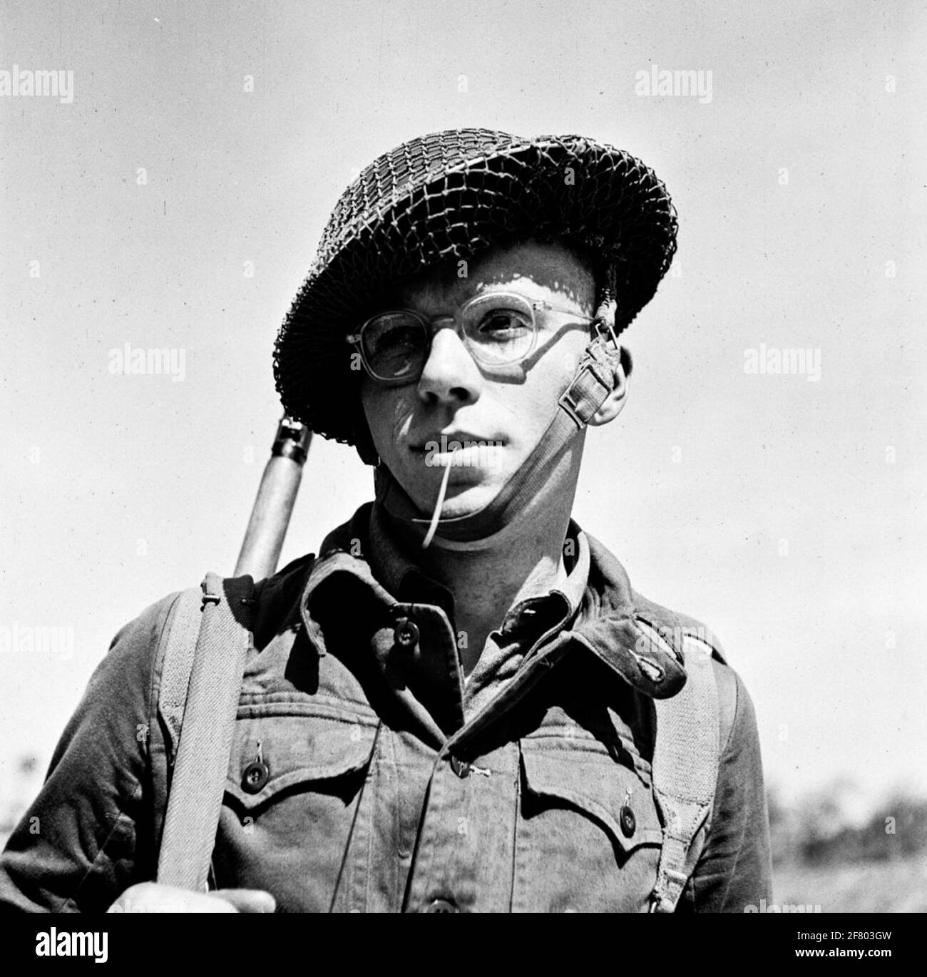 Infanterist in combat suit with the weapon to the shoulder and English model helmet. Stock Photo