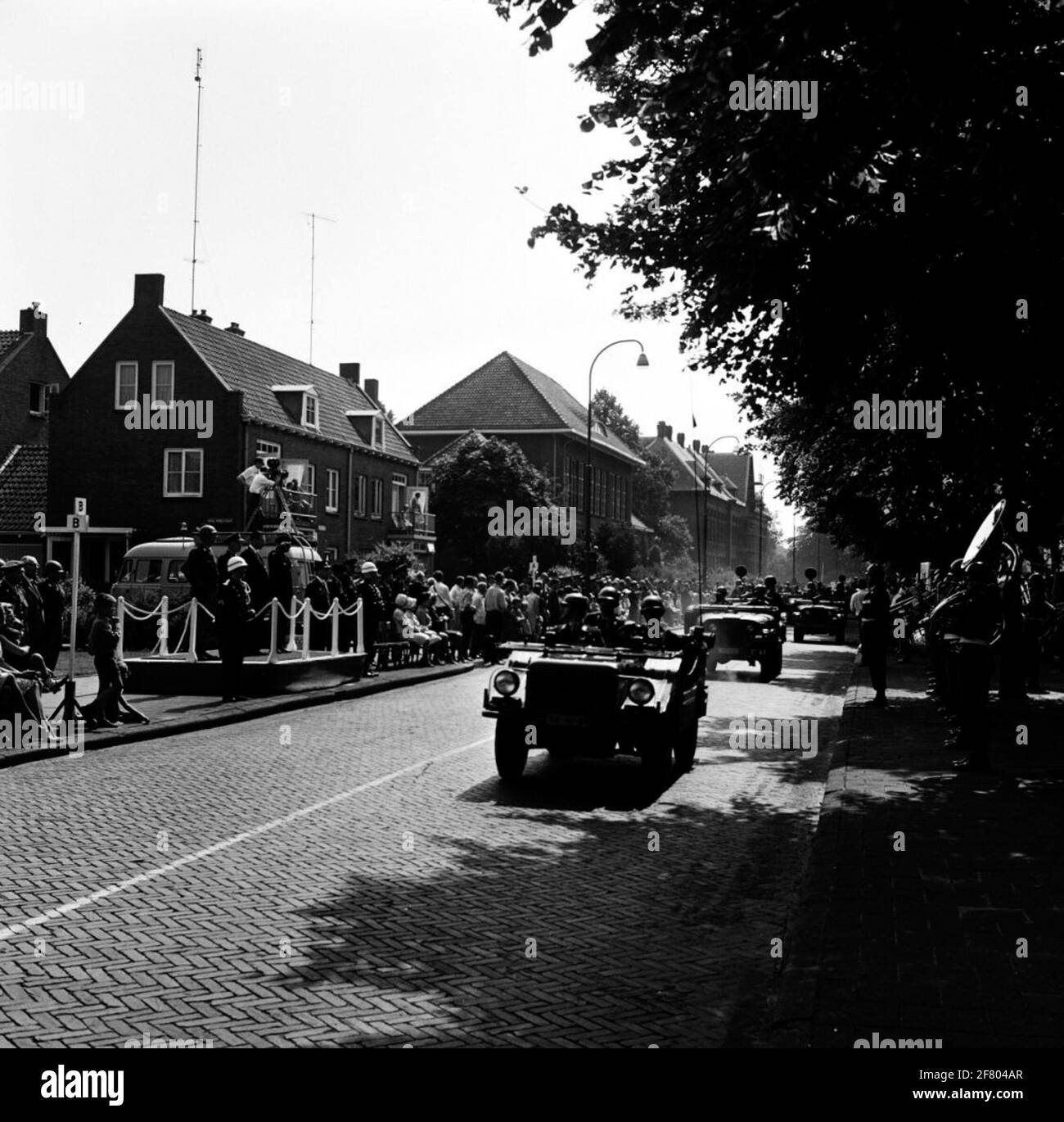 A DKW MUNGA, followed by two Nekaf M38A1 Jeeps, during a parade on the Ceintuurbaan in Deventer on the occasion of the fourth anniversary of the DEVENTER garrison. Behind a stage is a camera car where filmed from the parade. Stock Photo
