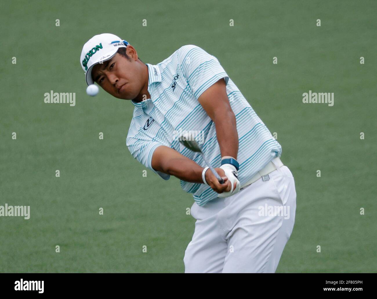 Golf - The Masters - Augusta National Golf Club - Augusta, Georgia, U.S. - April 10, 2021 Japan's Hideki Matsuyama chips onto the 2nd green during the third round REUTERS/Brian Snyder Stock Photo