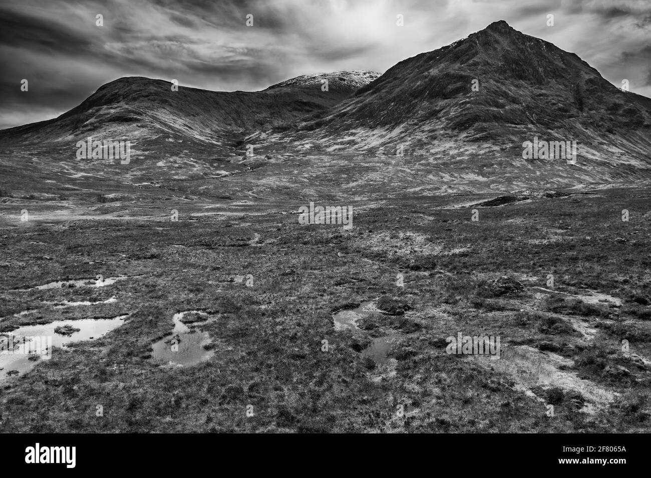 Flying drone dramatic  black and white landscape image of mountains rivers and valleys in Glencoe in Scottish Highlands on a Winter day Stock Photo