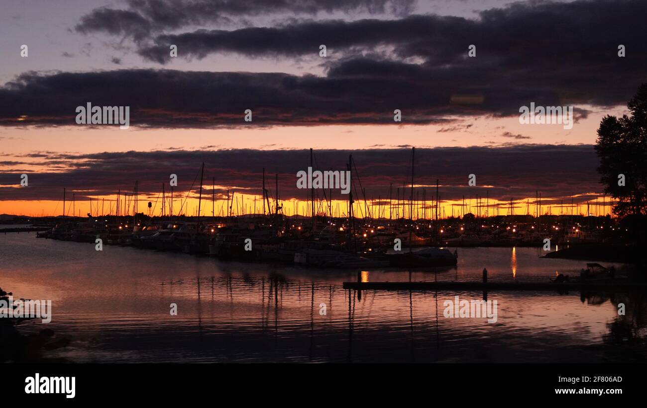 Beautiful sunset in Semiahmoo bay, BC, Canada, with lots of boats docked. Took it on cross border train from Vancouver to Seattle. Stock Photo