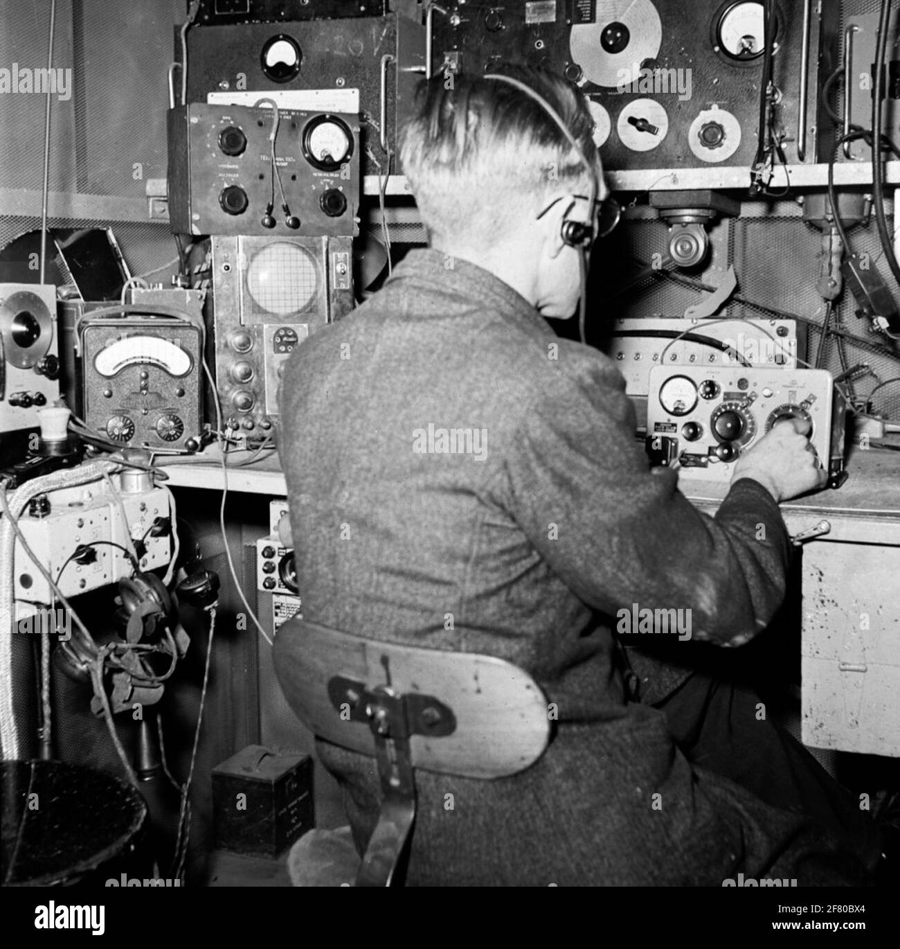 Civilian staff of the connecting troops are part of a z.g. 18 set. A portable transmission receiver, working on short wave with amplitude modulation. The lifespan of the road grieving was not very long. A subsequent renowned AVO universal meter is on the workbench. Stock Photo