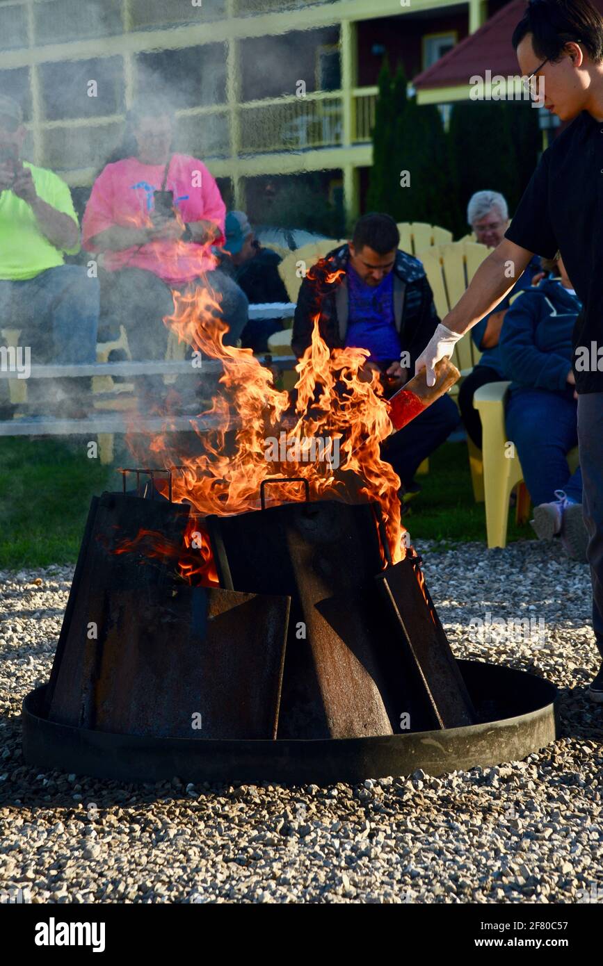 Crowds of tourists watching spectacle of traditional fish boil, finale kerosene-doused fire by boilmaster, Door County, Wisconsin, USA Stock Photo