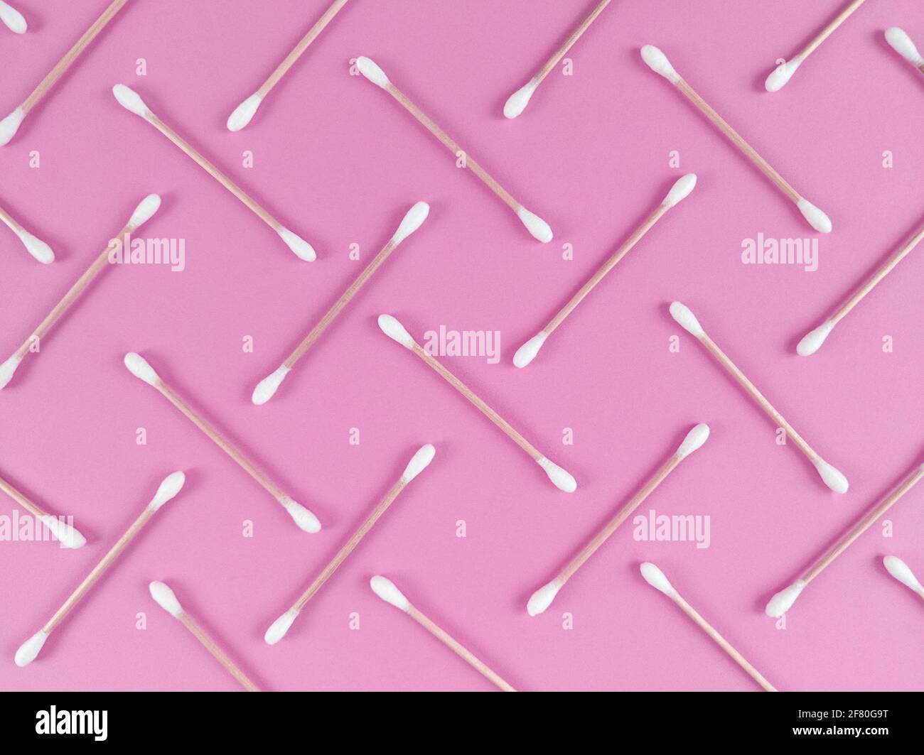 Pattern made from bamboo cotton buds on pink background. Stock Photo