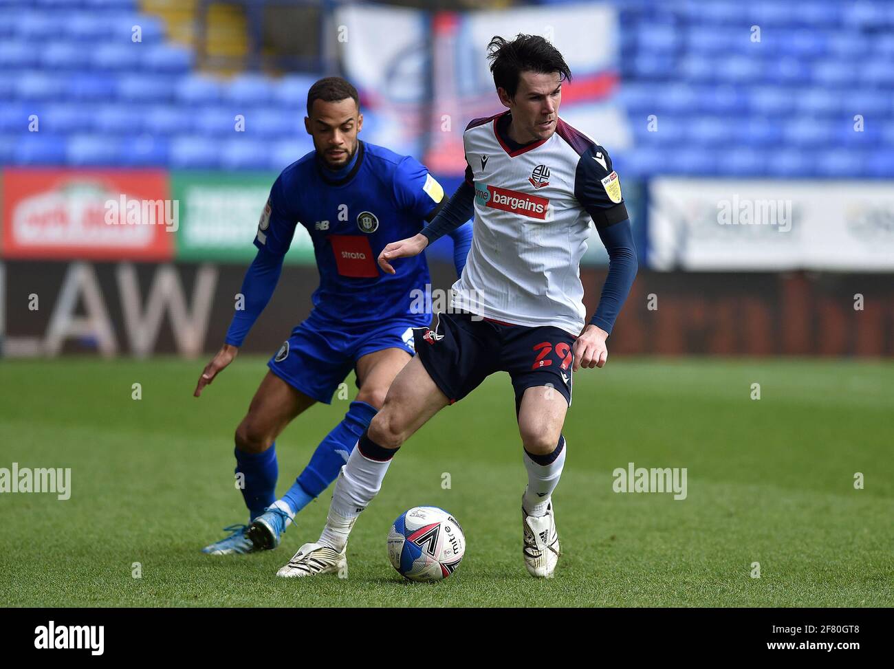 BOLTON, UK. APRIL 10TH Kieran Lee of Bolton Wanderers tussles with Warren  Burrell of Harrogate Town during the Sky Bet League 2 match between Bolton  Wanderers and Harrogate Town at the Reebok