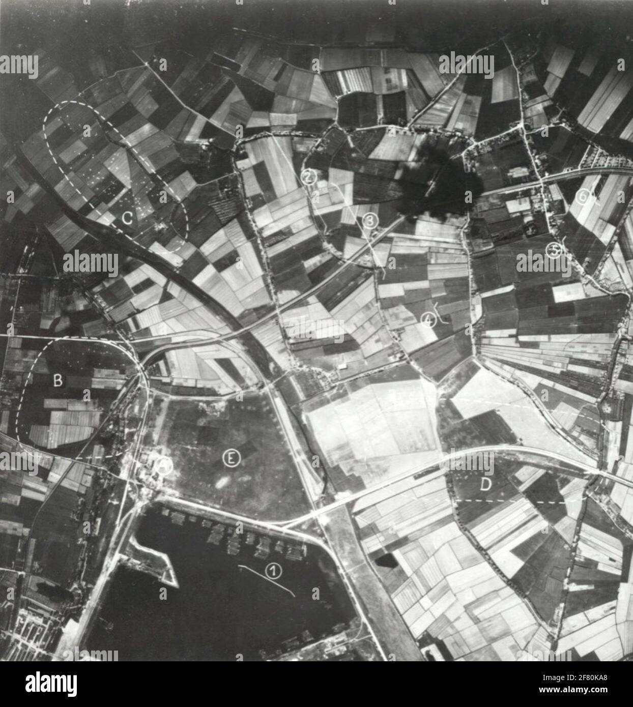 Waalhaven airport shortly after the German attack on 10 May 1940. On the ground in the circled areas, clearly visible the parachutes of the German paratroopers. Stock Photo