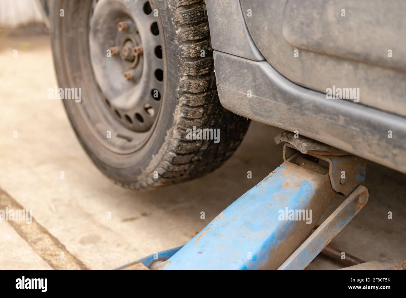 Car on the jack before replacing the wheel. Tire repair shop. Wheel
