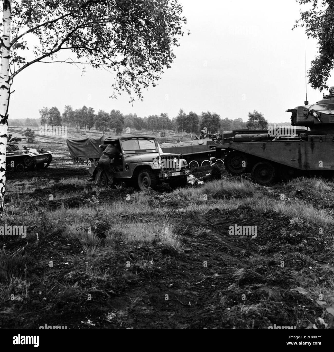 Inspector General Z.K.H. Prince Bernhard also visits the training grounds at Hohne during his working visit to 41 armored brigade. On the photo, a (exercise) wounded is made ready for drain by a jeep M38A1 Neck. On the right a Centurion MK 5 combat tank in the background two AMX-PRIs. Stock Photo