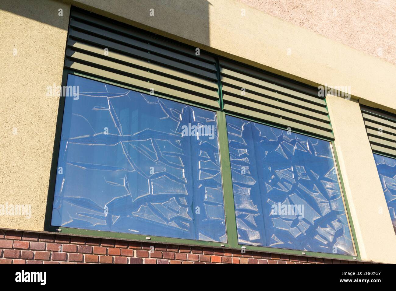 Tinting foil peeling off window panes because of strong sunshine Stock Photo