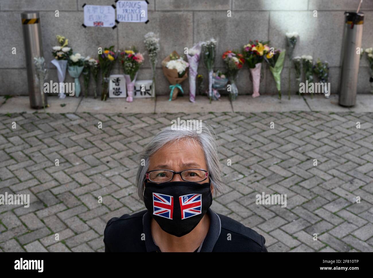 A woman wearing the United Kingdom theme face mask seen outside the embassy British Consulate General Hong Kong after the announcement regarding the death of Britain's Prince Philip in Hong Kong. Prince Philip, husband of Queen Elizabeth II died at 99 years old. Stock Photo