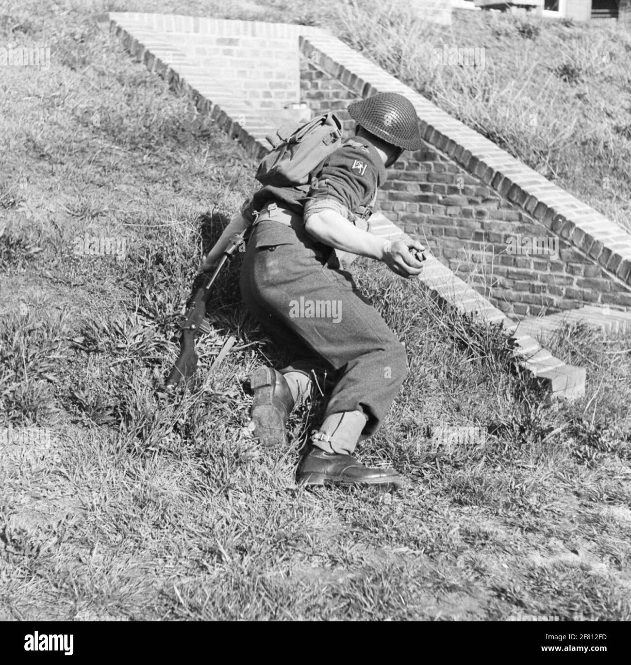 An infanterist ready to throw a (exercise) hand grenade. Stock Photo