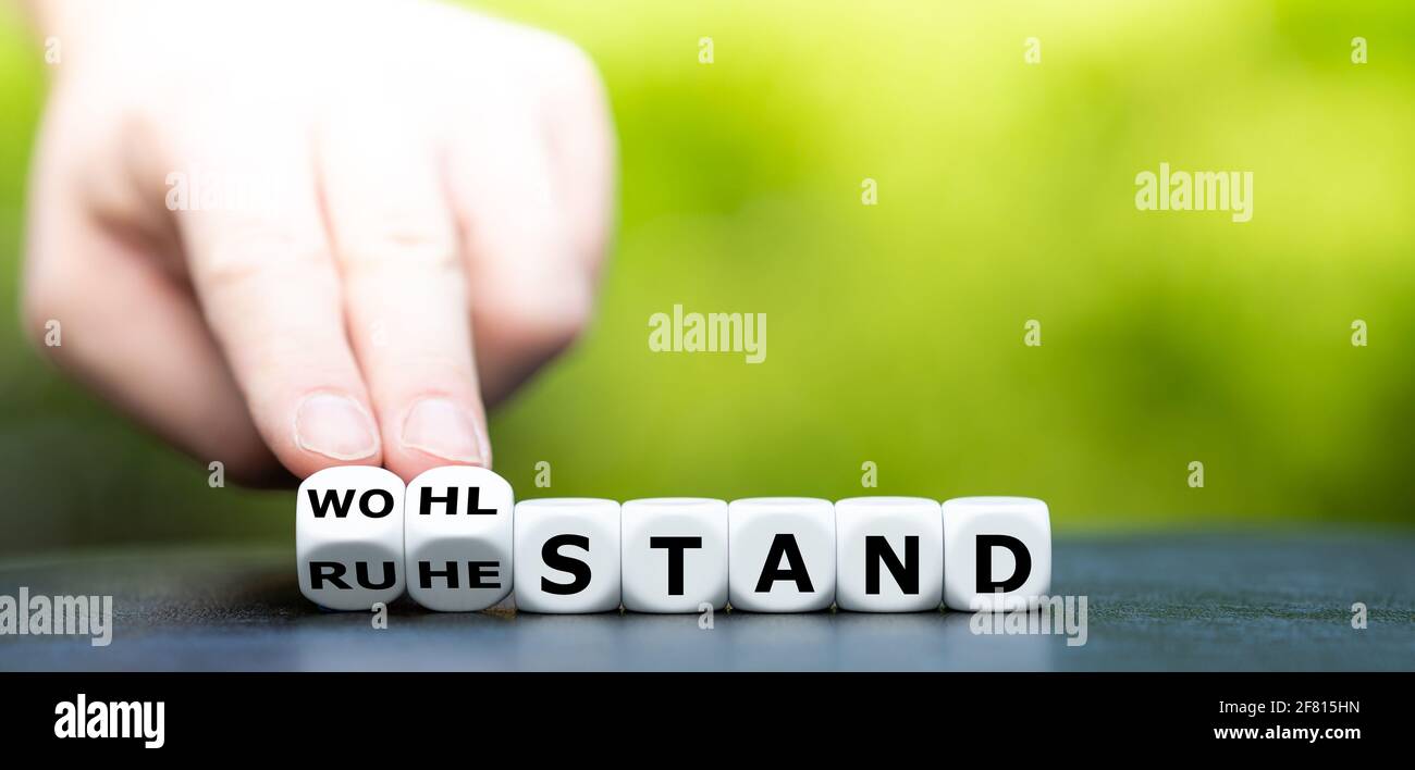 Dice form the German words "Ruhestand" (retirement) and "Wohlstand" (affluence). Stock Photo