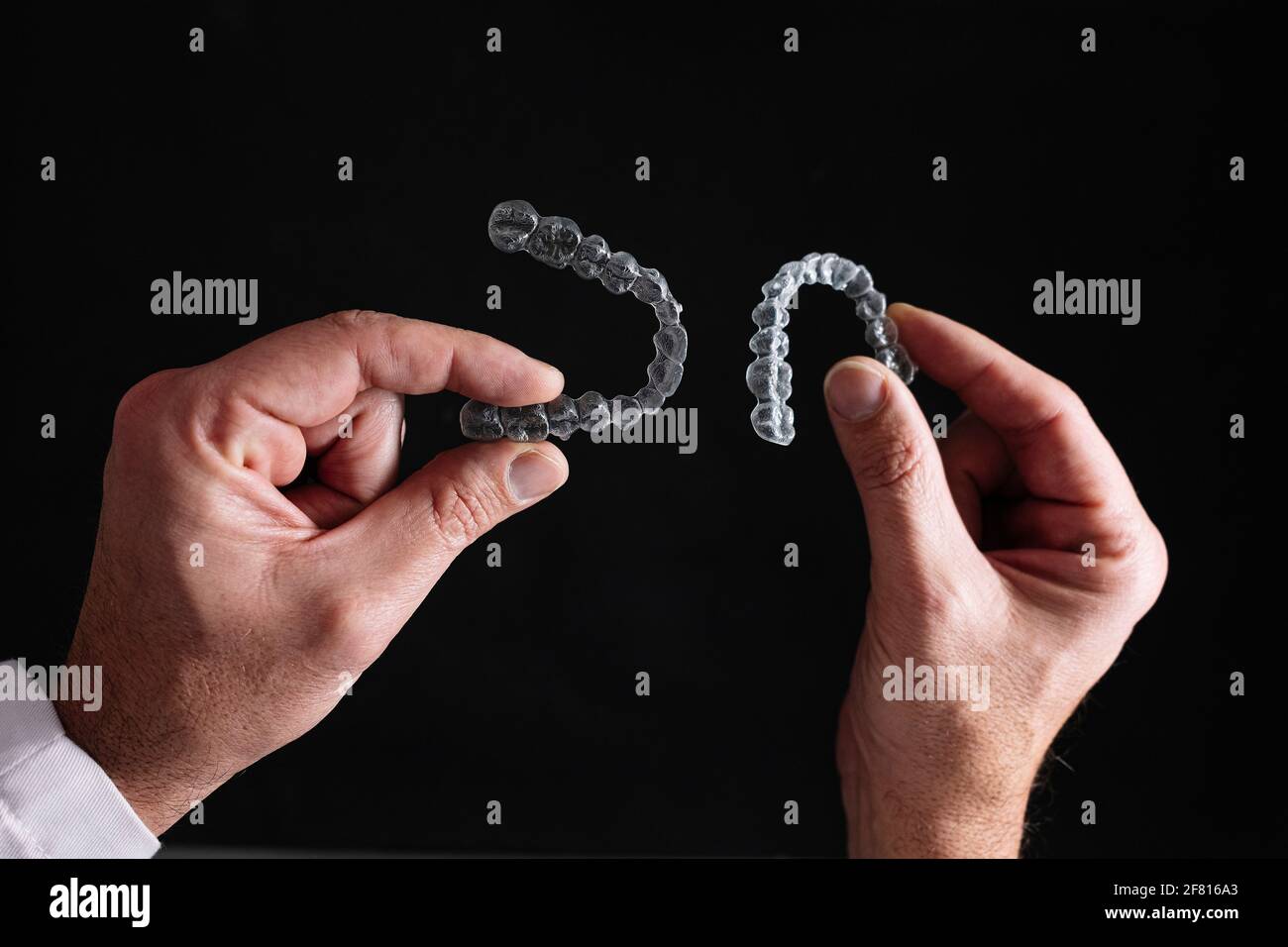 Doctor hands holding a transparent dental aligner Stock Photo - Alamy