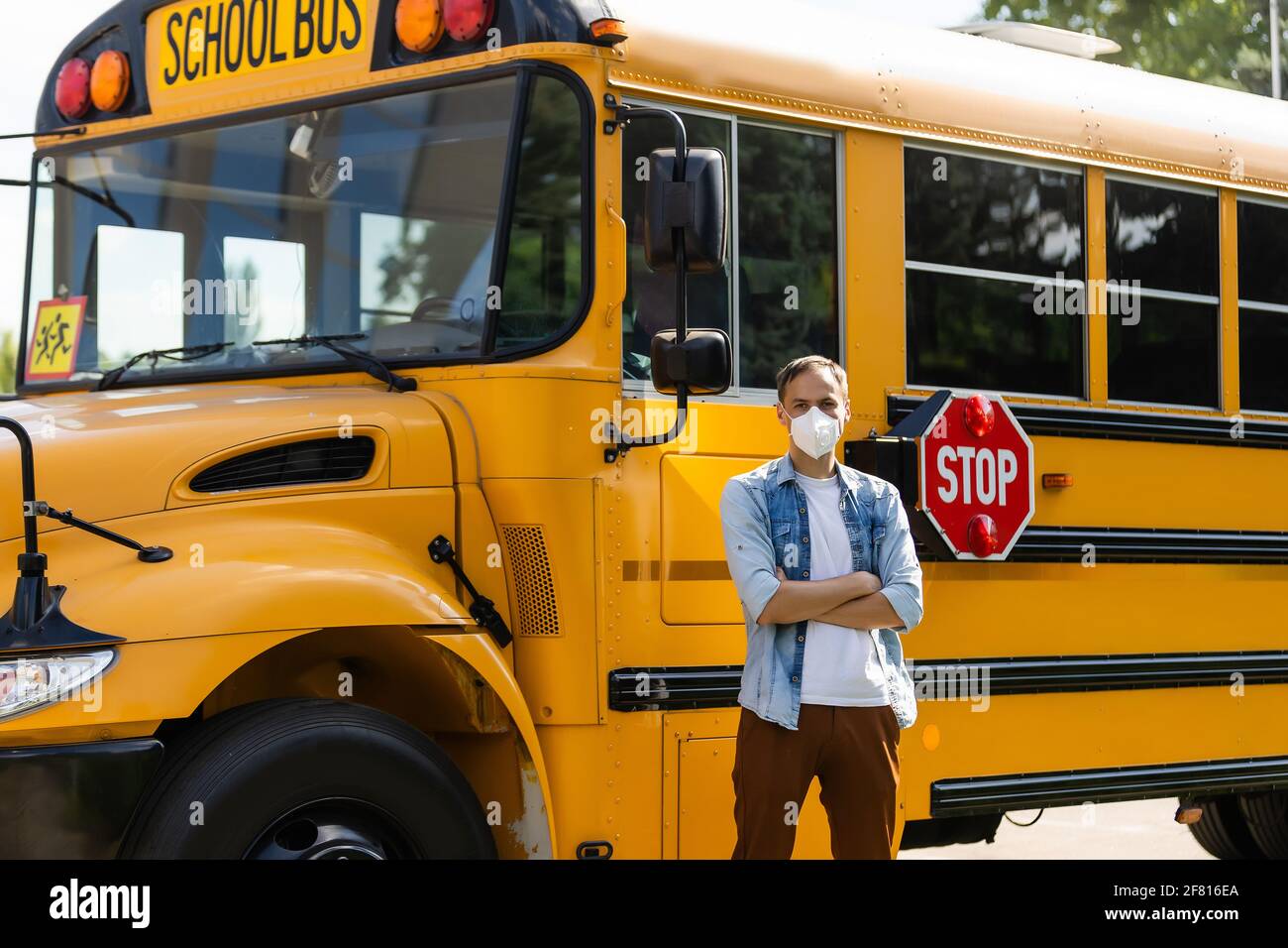 masked teacher near the school bus Stock Photo - Alamy