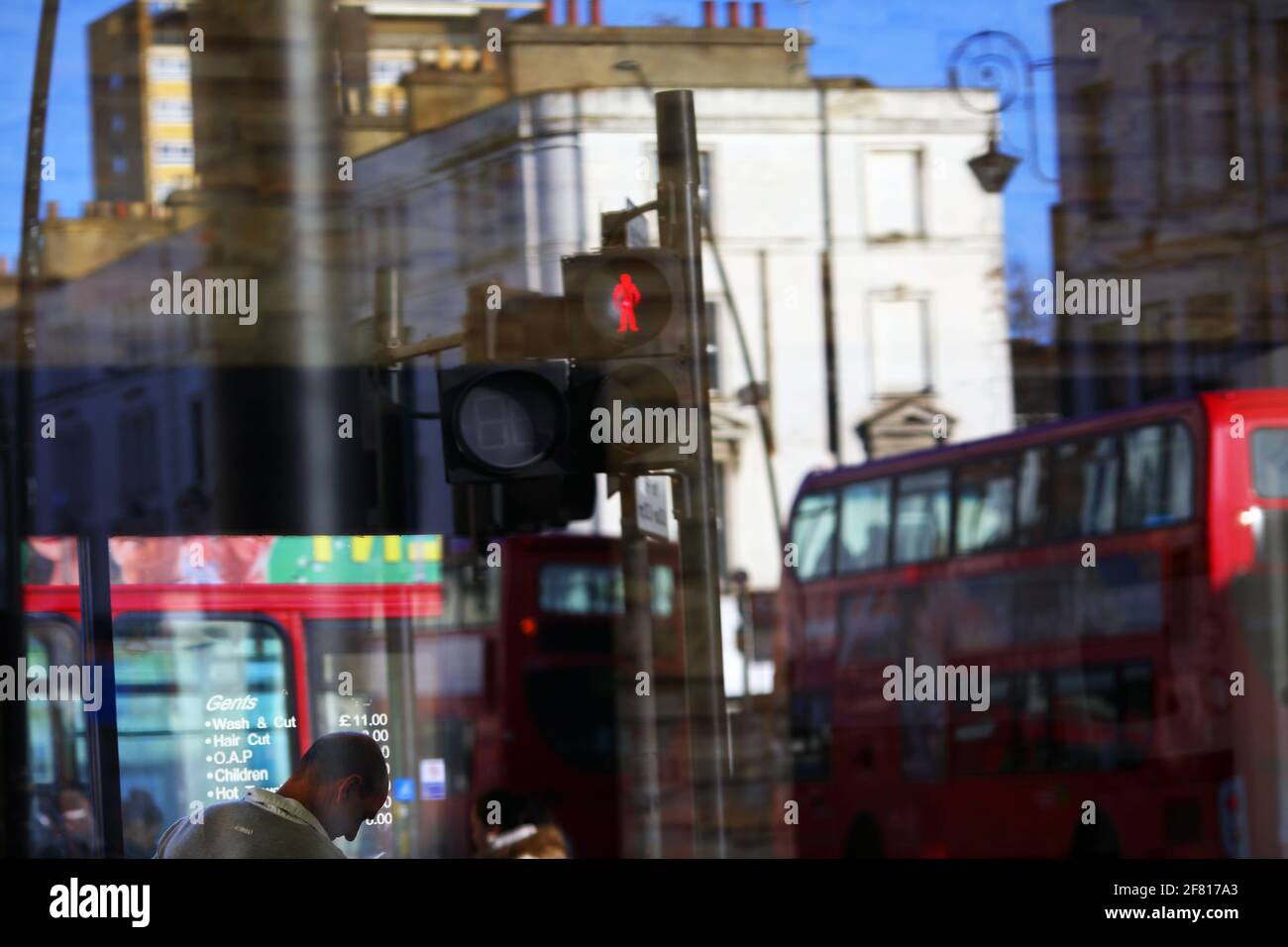 United Kingdom / London / reflection in window, London bus, traffic ,crossing road,colorful urban life in London . Stock Photo