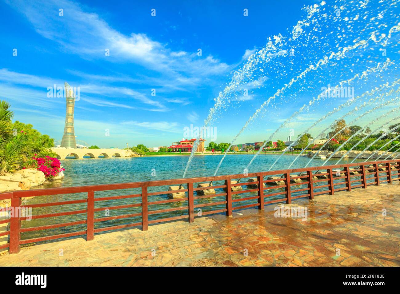 Doha, Qatar - February 21, 2019: Aspire Tower hotel and bridge with fountain in Aspire park, Doha's biggest park, located in Aspire Zone, Doha Sports Stock Photo