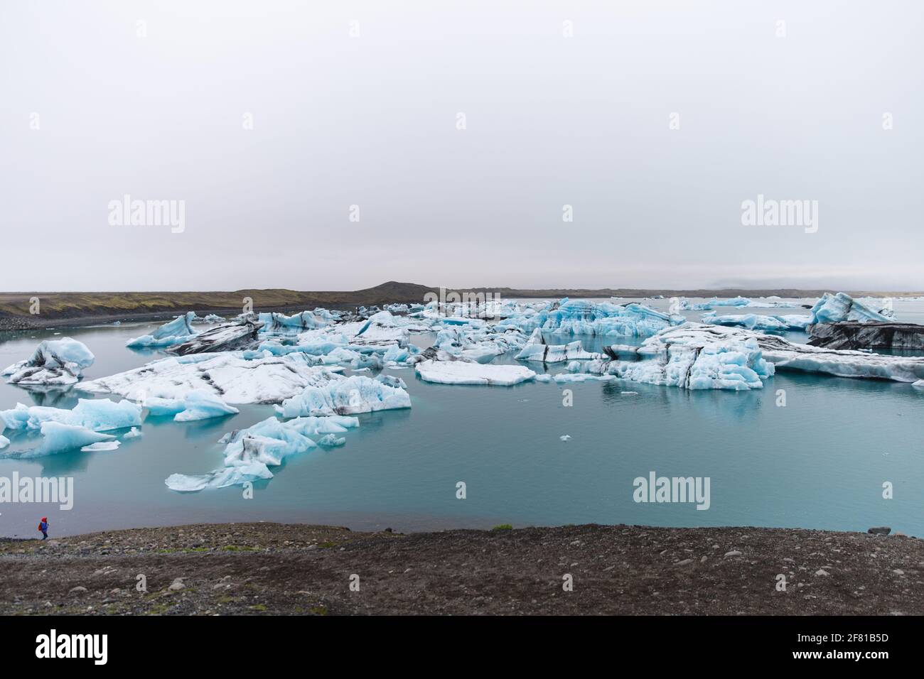 panoramic view of ice blocks floating in the water on a very cloudy day Stock Photo