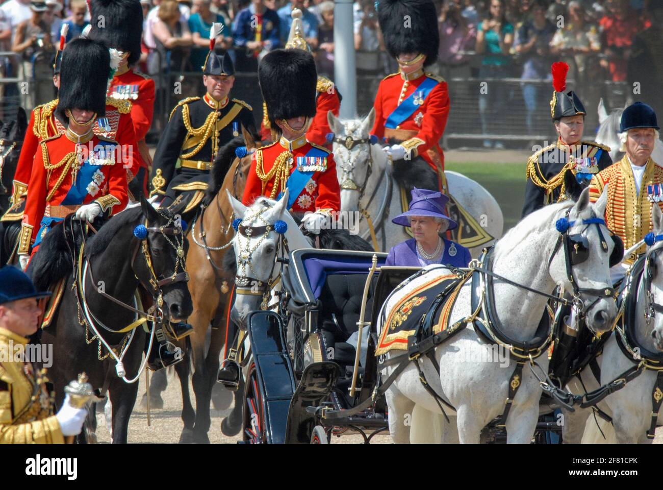 Trooping The Colour 17th June 2006. HRH The Queen rides in a carriage to her position for the event. HRH Prince Charles rides on horse back (left of frame) and HRH Princess Anne rides horse back (right of frame). Stock Photo