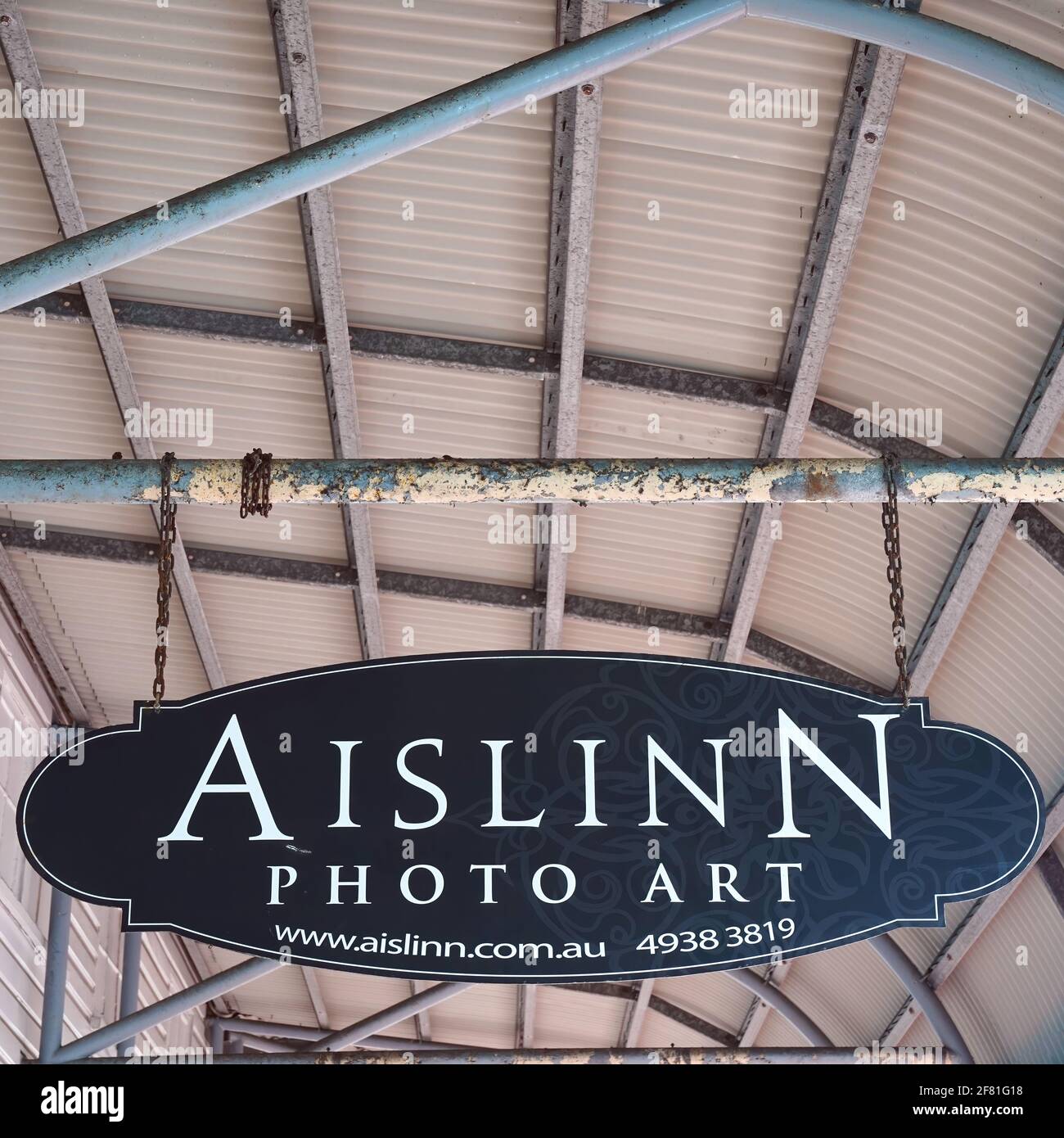 Yeppoon, Queensland, Australia - April 2021: Sign hanging by a chain ...