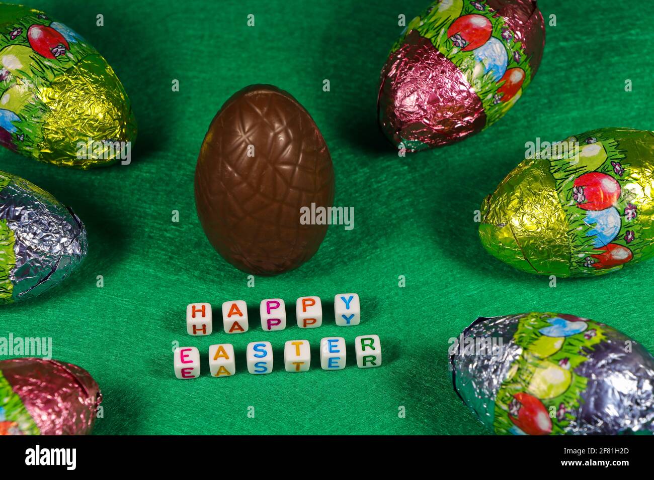 Happy Easter Chocolate Egg And Colorful Wrapped Eggs Stock Photo