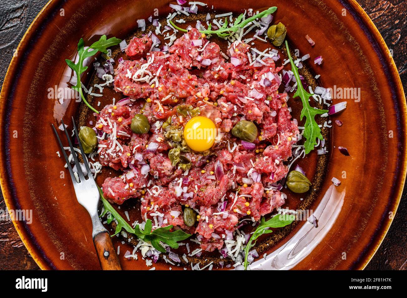 Beef steak tartare with raw egg yolk, pickled capers and Parmesan