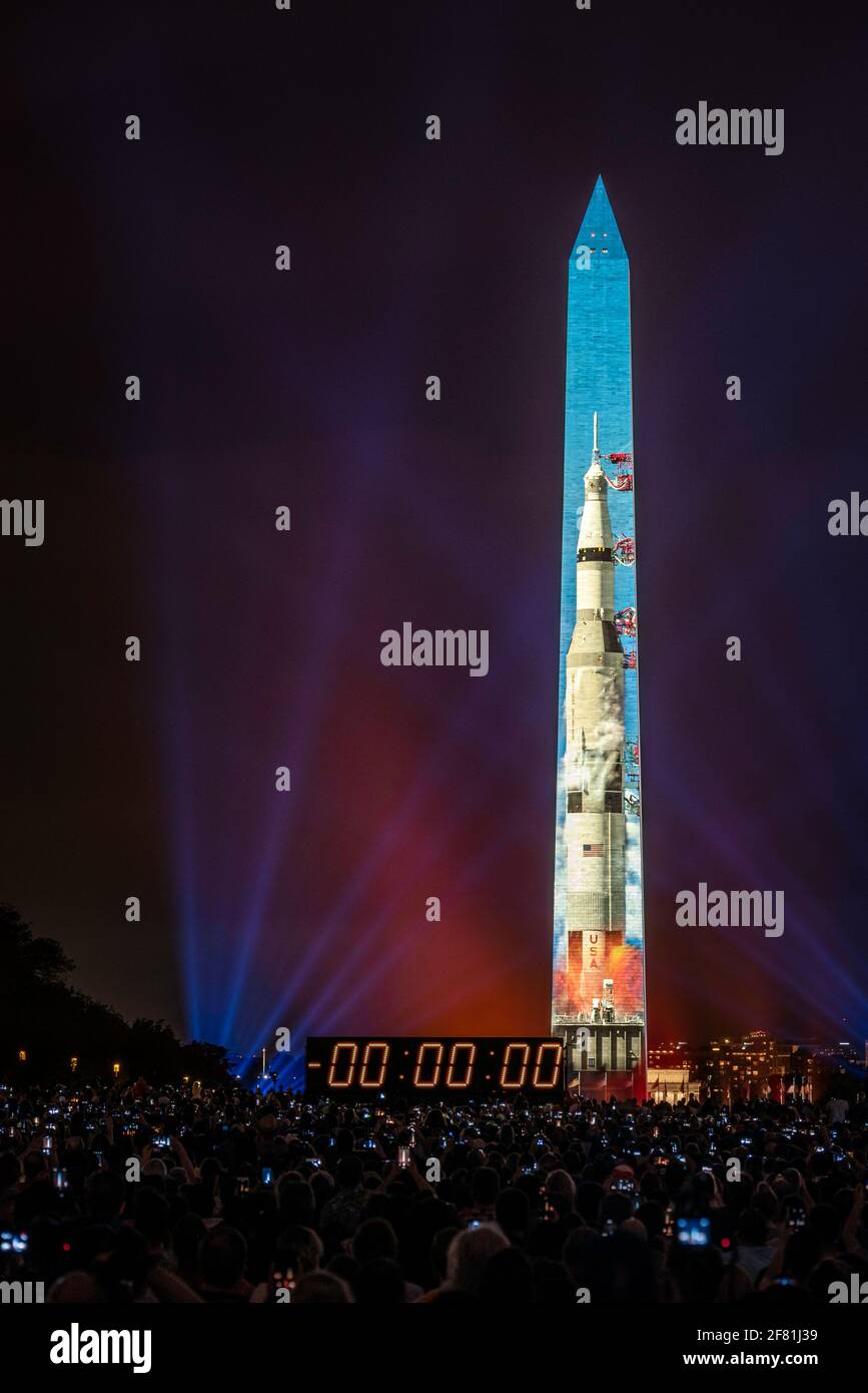 The Saturn V rocket lifts off in during the Go for the Moon, 50th Anniversary of the Apollo 11 Moon landing, projection on the Washington Monument. Stock Photo