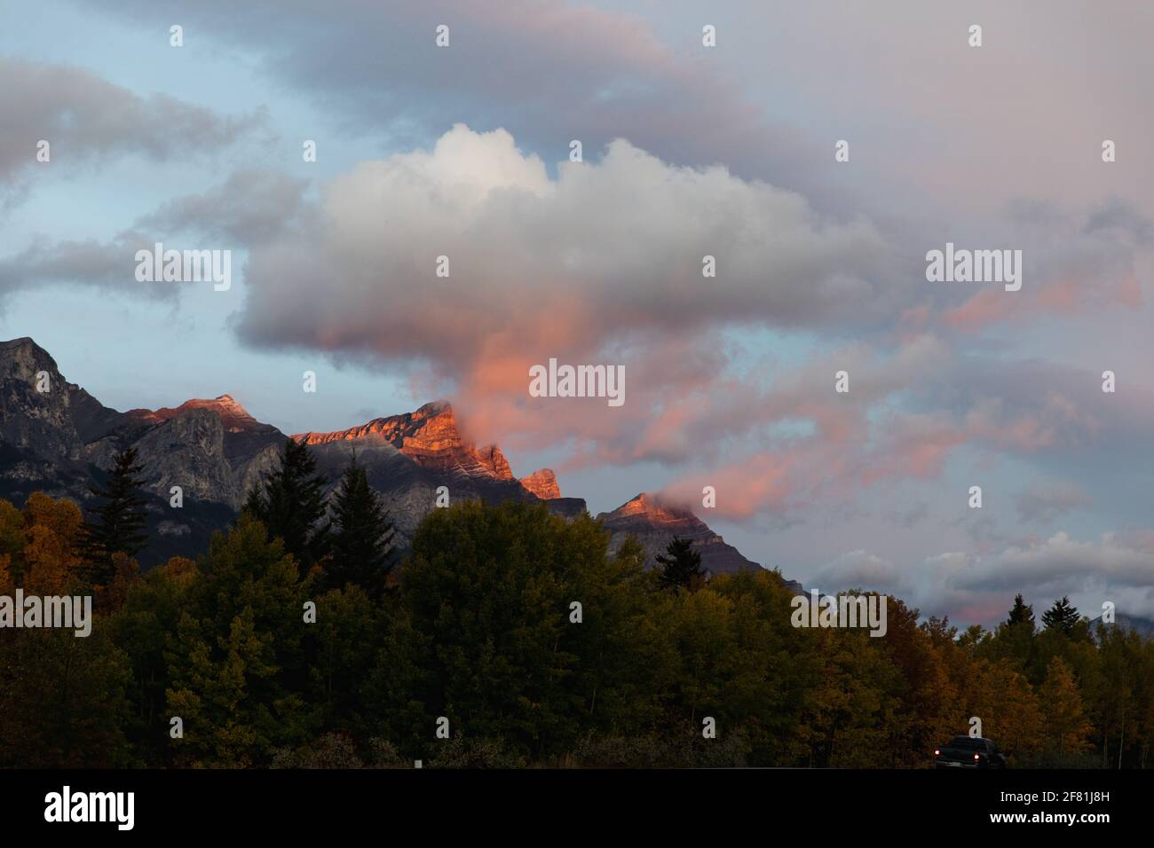 sunrise with bright pink light in the clouds in the mountains Stock Photo