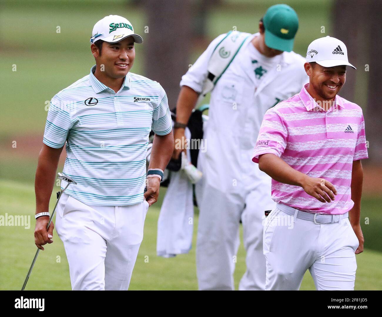 Augusta, USA. 11th Apr, 2021. Hideki Matsuyama, left, and Xander Schauffele are all smiles after they both made eagle putts on the 15th green during the third round of the Masters on Saturday, April 10, 2021, in Augusta, Georgia. (Photo by Curtis Compton/Atlanta Journal-Constitution/TNS/Sipa USA) Credit: Sipa USA/Alamy Live News Stock Photo