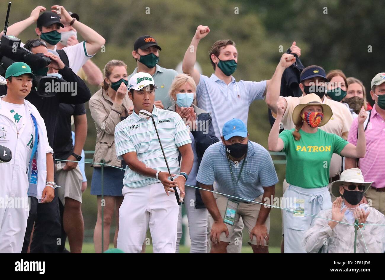 Augusta, USA. 11th Apr, 2021. The patrons react as Hideki Matsuyama chips it close to the cup from the gallery to save his par and finish in the lead at 11-under par during the third round of the Masters on Saturday, April 10, 2021, in Augusta, Georgia. (Photo by Curtis Compton/Atlanta Journal-Constitution/TNS/Sipa USA) Credit: Sipa USA/Alamy Live News Stock Photo