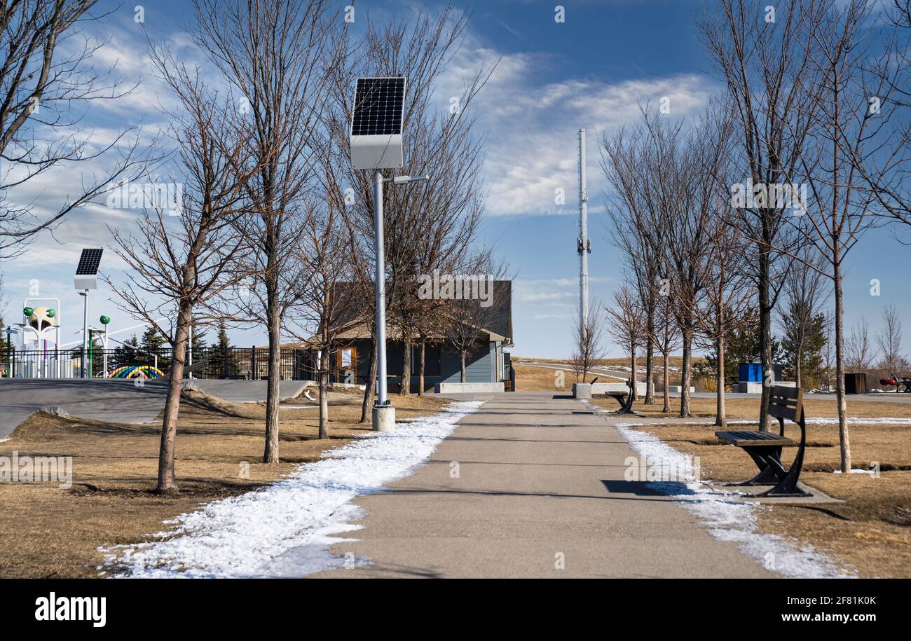 Solar panels charging street lights at a sustainable community park in Airdrie Alberta Canada. Stock Photo